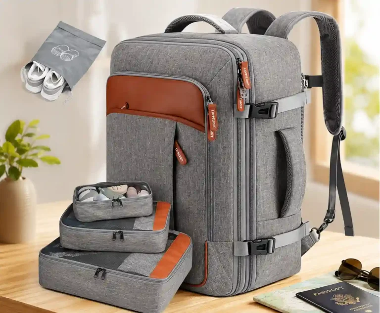 A gray travel backpack with brown accents and organized packing cubes, shoes, a map, sunglasses, and passport, representing the best backpack for long-term travel.