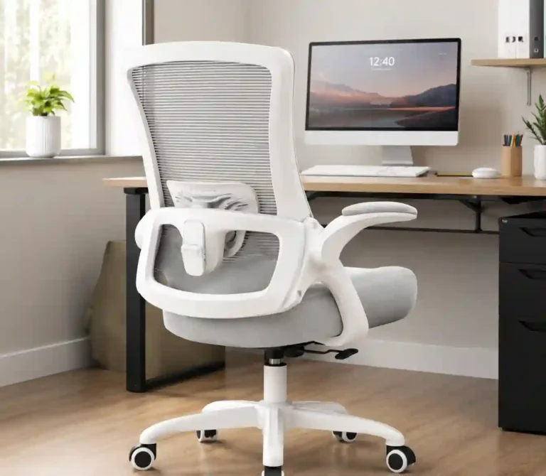 A white and gray ergonomic office chair with a breathable mesh back, lumbar support, padded armrests, cushioned seat, and adjustable base positioned at a modern home office desk.